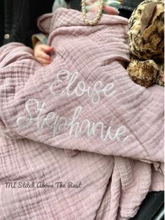 a baby wrapped in a pink blanket with the words close stephanie on it's chest