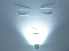 a woman's face is shown through the light