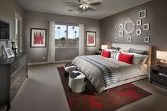 a bedroom with gray walls and red accents