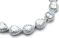 an elegant necklace with pear shaped diamonds on the sides and large, clear stones in the middle