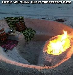 a fire pit sitting on top of a sandy beach