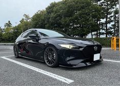 a black sports car parked in a parking lot