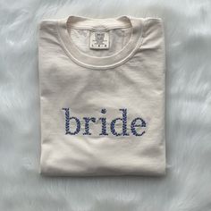 Introducing our bride floral t-shirt. This soft and cozy embroidered floral tee curated in house for the new bride to be! The delicate floral embroidery makes our bride tee the perfect engagement, wedding or bridal shower gift! Perfect to pair with jeans, and gold hoop earrings. A cute shirt to have on the morning of your wedding while you sip that cup of coffee and get ready for your big day. Also a FAVORITE to take on the honeymoon. The shirt is unisex, however if you are looking for a more ov Bride To Be Tshirt, Wedding Day Shirts, Bride Tshirt, Floral Embroidered Shirt, Bride Tee, Bridal Shirts, Bride Floral, Embroidered Shirts, Bride Shirt