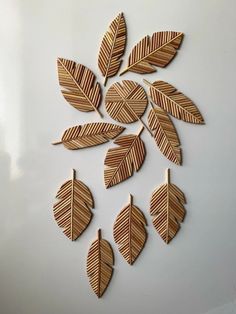 wooden leaves arranged in a circle on a white surface