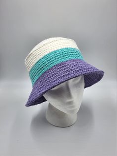 a white mannequin head wearing a multicolored crochet sun hat