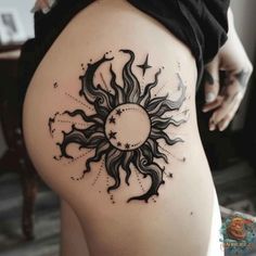 a woman's thigh with a sun and stars tattoo on it