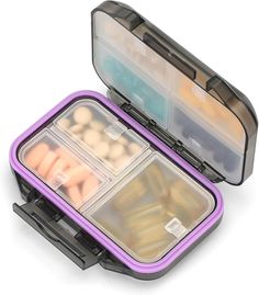 an open purple lunch box filled with lots of different foods and veggies in it