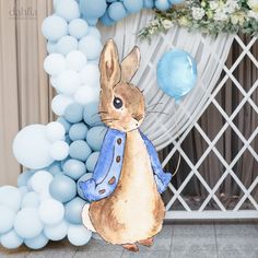 a watercolor painting of a rabbit holding a blue balloon in front of a backdrop