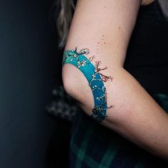 a woman with a tattoo on her arm