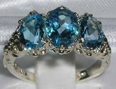 *This ring is made from 585 14K White Gold with Natural Semi precious Blue Topaz.*Total gem weight 3.4ctA beautiful Victorian / Antique Style Ring set with a center 8x6mm (0.32"x0.24" inches) & two 7x5mm (0.28"x0.20" inches) oval cut Blue Topaz in a gorgeous 14ct White Gold setting. *Total Height 5mm, Width 16mm, Length 11mm Completely made from Solid English 14K Gold Hallmarked by the London Assay Office which confirms the rings authenticity. The Hallmark includes the 585 marking for 14K Go Eternity Band Engagement Ring, Topaz Wedding Ring, Trilogy Engagement Ring, Antique Style Rings, Blue Topaz Engagement Ring, Trilogy Ring, Topaz Engagement Ring, Yellow Gold Setting, Alternative Engagement Rings