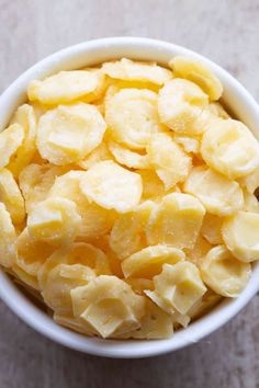 a white bowl filled with sliced bananas on top of a table