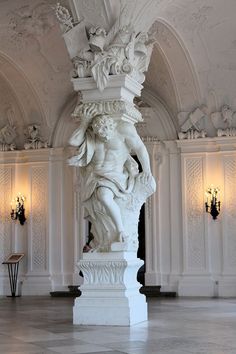 a white statue in the middle of a room