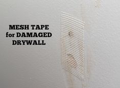 a dirty wall with the words mesh tape for damaged drywall