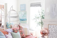 a living room filled with lots of furniture and pillows on top of a wooden table