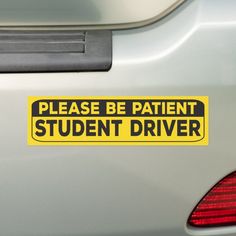 a yellow sticker that says please be patient student driver