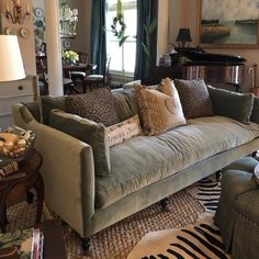 a living room filled with furniture and a piano