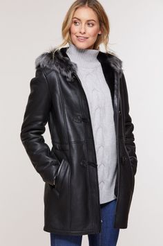 Women's Fur Sheepskin Parka Leather Coat In Black Indulge in luxury with our women's fur sheepskin parka leather coat. Crafted from real sheepskin with a semi-aniline finish, it features a cozy faux shearling inner, a hooded fur collar, and a practical button closure. The open hem cuffs, two side pockets, and a sleek black color add both style and functionality to this chic winter essential. Outer Shell: Real Leather Leather Type: Sheepskin Leather Finish: Semi-aniline Inner Shell: Faux Shearling Feature: Hooded Fur Collar Closure Style: Button Collar Style: Hooded Cuffs Style: Open Hem Inside Pockets: One Outside Pockets: Two Side Pocket Color: Black Classic Sheepskin Fur Coat With Faux Fur Lining, Classic Sheepskin Coat With Faux Fur Trim, Classic Sheepskin Fur Coat With Faux Fur Trim, Elegant Shearling Outerwear, Luxury Leather Coat For Cold Weather, Luxury Black Sheepskin Fur Coat, Elegant Shearling Fur Coat For Cold Weather, Black Sheepskin Leather Jacket With Faux Fur Trim, Black Leather Fur Coat For Cold Weather