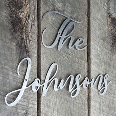 the words, the johnsons are cut out of wood and placed on top of each other