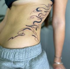 a woman with a tattoo on her stomach