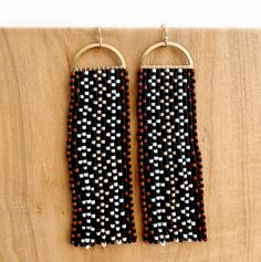 Tvpushnik in the Choctaw language translates to basket. This design is inspired by traditional Choctaw river cane basketry. These hand-beaded earrings with an unfinished open half-round brass top have thirteen fringes with a basket weave diamond motif. Tvpushnik contains 676 delicate glass beads in each earring and is 3" long tradition gloss black, white, neon red, matte turquoise on sterling silver-plated findings, sterling silver ear wires flora gloss forest green, deep pink, eucalyptus, on ra Traditional Brown Beaded Fringe Earrings, Traditional Woven Dangle Jewelry, Traditional Brown Handwoven Beaded Earrings, Traditional Woven Earrings, Traditional Handwoven Gold Beaded Earrings, Traditional Gold Handwoven Beaded Earrings, Traditional Fringe Earrings, Traditional Handwoven Brown Earrings, Traditional Brown Handwoven Earrings