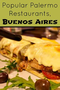 a close up of a sandwich on a plate with olives next to it and the words popular paleno restaurants, buenos aries