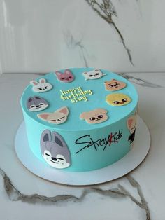 a birthday cake decorated with stickers and animals