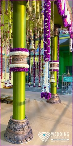 a green pillar with lots of beads hanging from it's sides