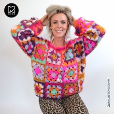 a woman sitting on top of a leopard print chair with her hands behind her head