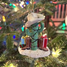 a cactus ornament hanging from a christmas tree