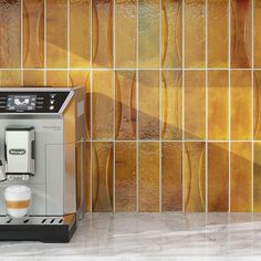 an espresso machine sitting next to a tiled wall