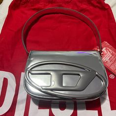 Structured And Compact, This Iconic Women's Bag Has A Handle That Fits Over The Shoulder And An Optional Strap For Crossbody Wear. The Electroplated Oval D Plaque On The Flapsignature Element Of The Stylematches The Glossy, Mirrored-Leather Construction. The Red Variant Of This Item Is A Limited Edition. Minor Scratch At Back Of Bag (Please See - Can’t Even Notice!) Comes With Cross Strap Too. Never Opened. Sealed. Diesel Bag, Iconic Women, Cross Straps, Women's Bag, Leather Bag, Limited Edition, Bag Lady, Mirror, Leather