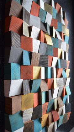 a sculpture made out of wooden blocks in the shape of an abstract wall art piece