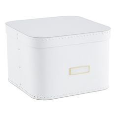 a white box with a gold handle on the front and bottom, sitting on a white surface