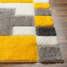 a yellow and gray rug on the floor