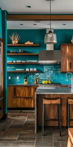 a kitchen with teal walls and wooden cabinetry is pictured in this image, there are two stools at the center of the island