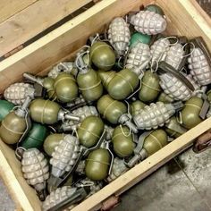 a crate filled with lots of green and white ornaments in it's sides,