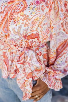 Details Multi Paisley Print Off The Shoulder Belted Blouse Fabric has no stretch Elastic waistband, neckline and sleeves Removable belt Pair this blouse with jeans and heels! Lined Size small from shoulder to hem: 16" Material and Care 100% polyester Machine wash cold, no drum drying Patterns may vary Materials may have natural variations Colors may vary from different viewing devices. Pink Long Sleeve Paisley Print Blouse, Summer V-neck Paisley Print Blouse, Summer Paisley Print V-neck Blouse, Summer Paisley Print Top With 3/4 Sleeves, Belt Blouse, Fringe Clutch, Paisley Print 3/4 Sleeve Summer Top, White Jean Shorts, Pink Lily