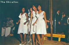 three women in white dresses standing next to each other with microphones on their heads