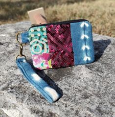 "Eye-catching and functional, this little wristlet features both reclaimed Indigo, hand-dyed batik and some sequins for bling! The detachable wrist strap even doubles as a simple keychain. This practical little pouch measures 5.5\"w x 3.5h and is perfect for your cards, some cash and lip gloss. This product is handmade by the women of Edinam Designs in Ghana, West Africa.  Edinam exists to promote training and employment for the women of Ghana.  With this purchase, you get to be part of that end Adjustable Bohemian Wristlet For Everyday, Multicolor Rectangular Wristlet With Strap, Multicolor Rectangular Wristlet With Wrist Strap, Simple Keychain, Design Batik, Pouch Design, West Africa, Wrist Strap, Clutch Handbag