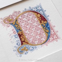 the letter d is made up of ornate designs on white paper with gold and blue accents