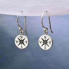 Sterling Silver Compass Dangle Earrings 27x10mm TA832 -SV-EARR These sterling silver compass earrings celebrate progress and change. The compass has long been used as an instrument to indicate the direction of the changing winds, and represent protection, luck, and guidance.  Sold by the Pair. Great for a graduate or anyone taking on a new journey. So sail away on the shining seas, and always find your way home. We will do our absolute best to process and ship your order within 24 hours. Personalized Round Sterling Silver Earrings, Personalized Classic Silver Earrings, Personalized Round Silver Earrings, Food Charms, The Compass, Find Your Way, Monogram Jewelry, Linking Rings, New Journey