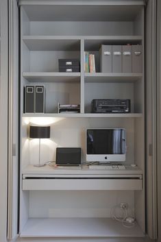 a white desk with a computer on top of it