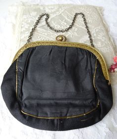 GORGEOUS antique French evening purse/bag. This French made handbag has an exceptionally beautiful brass frame, made with attention to detail and striking pattern. Finely detailed, beautiful design in black silk with aged gold thread decor. The silk has a couple of splits on one side, but detracting. The interior still has it's pink silk lame lining and has the original mirror still attached by the original gold thread. The closing is a 'kiss' closing that is working,just wonderful. It measures Vintage Evening Bag For Vintage Events, Vintage Evening Shoulder Bag, Vintage Shoulder Bag With Brass Hardware For Evening, Vintage Evening Bag, Vintage Gold Shoulder Bag For Formal Occasions, Victorian Handmade Evening Bag For Formal Occasions, Antique Handmade Bags For Vintage Events, Antique Clutch Evening Bag For Vintage Events, Handmade Vintage Evening Bag For Vintage Events