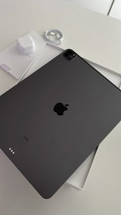 an apple laptop computer sitting on top of a white table