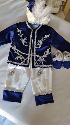 a baby's blue and white outfit with matching shoes