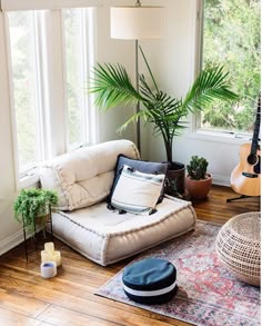 a living room filled with furniture and a guitar