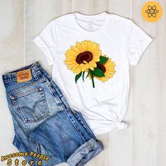 "All T-Shirt apparel are printed using direct-to-garment (also known as DTG). In addition, our inks are water-based and eco-friendly. This makes them feel much softer than traditional screen printed shirts, but just as durable. Sunflower Tee, Vintage Sunflower Shirt, Design Art, Sunflower Tee Shirt, Sunflower, Sunflower T Shirt, Sunflower Shirt, Sunflower Party **All sales are final and we don't accept returns. this is a customized and personalized product, and can not be resold. If we made a mi Casual White T-shirt With Sunflower Design, Crew Neck Cotton T-shirt With Sunflower Design, Yellow Short Sleeve T-shirt With Sunflower Design, Yellow Sunflower Print Graphic Tee, Cotton T-shirt With Sunflower Design, White Crew Neck Shirt With Sunflower Print, White Sunflower Print Graphic Tee, Custom Print Short Sleeve Sublimation Design For Spring, Relaxed Fit Short Sleeve T-shirt With Sunflower Design