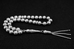 925 Sterling Silver Rosary 925 Ayar Gümüş Tespih Prayerbeads Silver Rosary Tesbih Tespih Tasbih Silver rosary with 33 beads Weight of rosary: 20.7 Gram PRICE INCLUDES SHIPPING We try to take photos that look as real as possible. However, it cannot be ruled out that color deviations may occur due to light or settings. This is not a reason for complaint. We can send you a product video before your purchase if you wish. Silver Hand-strung Rosary As Gift, Handmade Silver Rosary With Round Beads, Handmade Silver Traditional Rosary, Handmade Traditional Silver Rosary, Traditional Silver Rosary With Polished Beads, Traditional Handmade Silver Rosary, Traditional Silver Rosary As Gift, Silver Rosary, Product Video