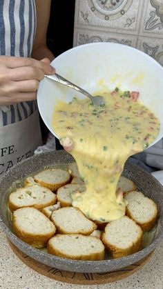 a person pouring sauce on some bread in a bowl