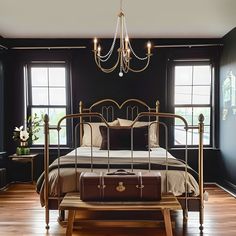 a bed room with a neatly made bed and a chandelier